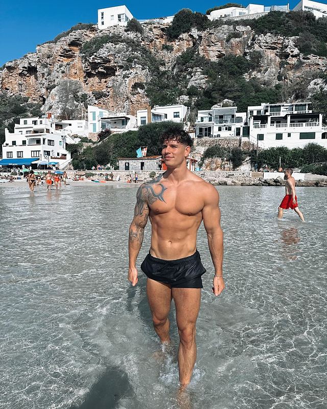 Luke in the sea below a white village (Instagram post)